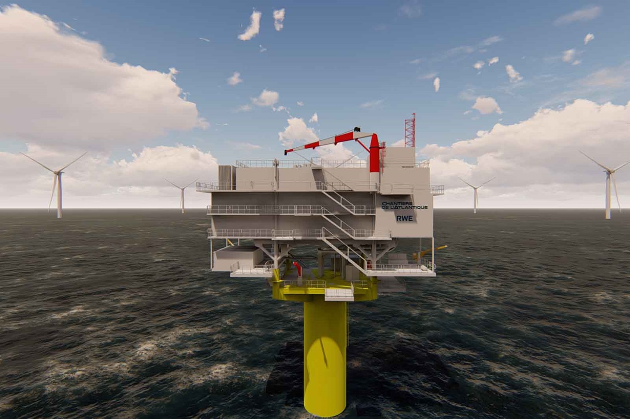 Une plateforme offshore avec une base jaune et plusieurs éoliennes à l'arrière-plan. Le ciel est nuageux.